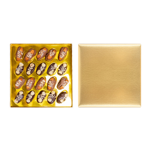 Golden Choco Gift box of chocolate-covered dates with nuts from kingdomdatesuae, showcasing glossy dates with nut toppings.