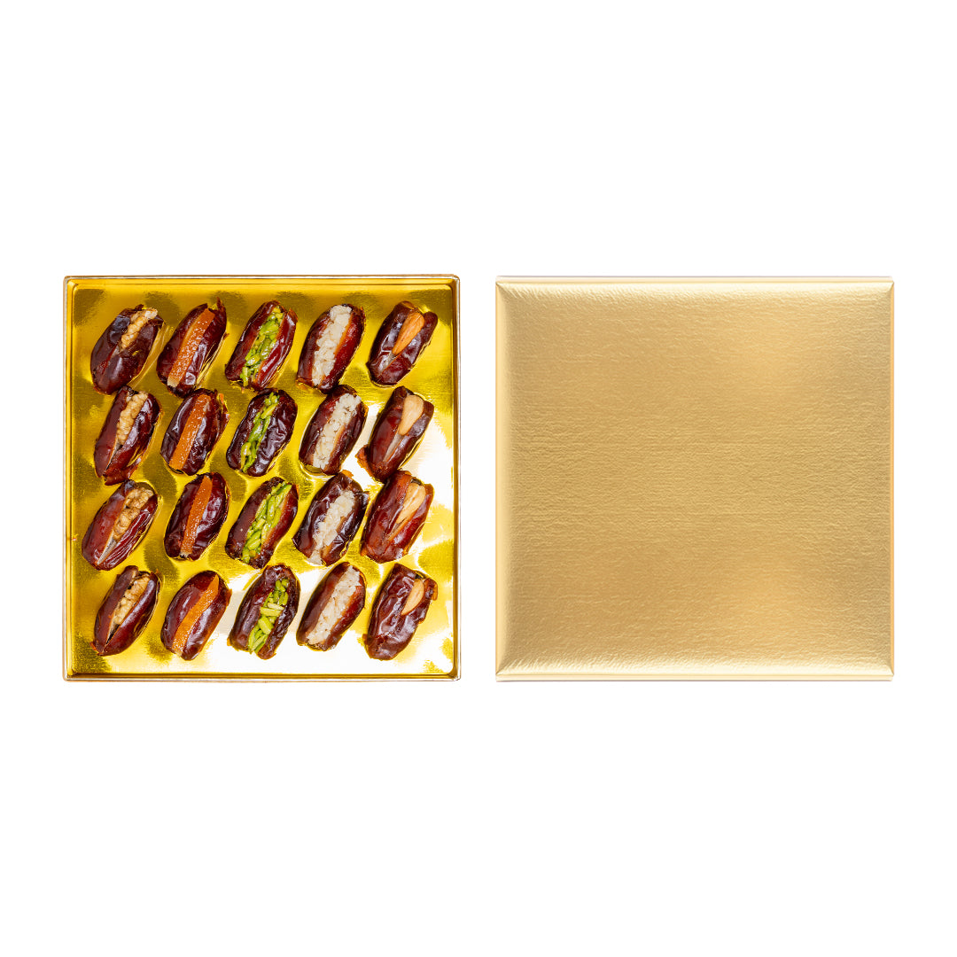 Golden stuffed dates with nuts from Kingdom Dates UAE, 330g premium selection, showcasing shiny dates filled with nuts.