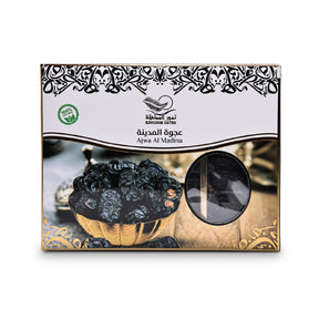 Assorted Ajwa Al Madina Dates from Kingdom Dates UAE in a clear display, showcasing their dark, glossy, and plump appearance.