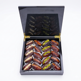 Majdoul dates with nuts in a sleek piano-finish carbon wooden gift box by Kingdom Dates UAE.