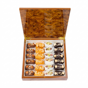 Assorted dates with nuts and signature chocolate in a desert sand wooden gift box from Kingdom Dates UAE.