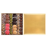 Assorted chocolates in a gold box on a white background