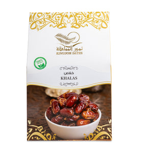 Close-up of fresh Khalas dates from Kingdom Dates UAE, showcasing their glossy, caramel-colored skin and plump texture.