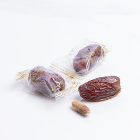 Wrapped Majdoul large dates from Kingdom Dates UAE, showcasing glossy, plump, and rich-textured dates in a natural setting.