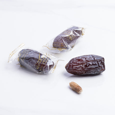 Wrapped Majdoul Jumbo Dates from Kingdom Dates UAE, showing plump, glossy, and large dates in a natural presentation.