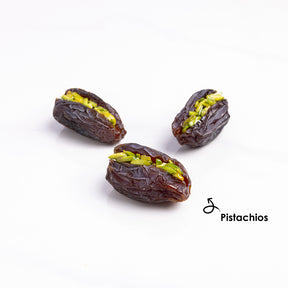 Premium stuffed dates with pistachios from Kingdom Dates UAE, showing glossy Medjoul dates filled with chopped pistachios.