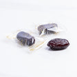 Wrapped Safawi Al Madina dates from Kingdom Dates UAE, showcasing plump, glossy, dark brown dates in a clear wrapping.