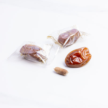 Wrapped Sultan Dates from Kingdom Dates UAE, showcasing glossy, plump dates in elegant packaging.