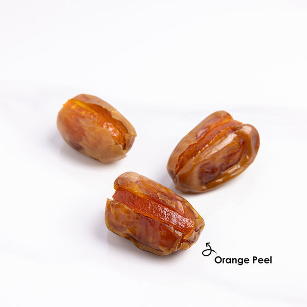 Premium stuffed dates with orange peel from Kingdom Dates UAE, showing glossy dates filled with orange peel slices.