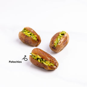 Premium stuffed dates with pistachios from Kingdom Dates UAE, showing glossy dates filled with green pistachios.