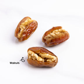 Premium stuffed dates with walnuts from Kingdom Dates UAE, showcasing glossy dates filled with crunchy walnuts.
