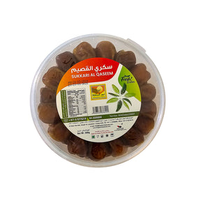 Fresh Sukkari Al Qasim dates in a 500g pack from kingdomdatesuae, showcasing glossy, ripe dates on a white background.