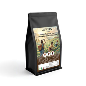 Jewels by Kingdom Dates Arabica dark roast coffee beans, medium roast, showing whole, shiny coffee beans in a close-up image.