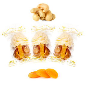 Wrapped cashew chocolate dates from Kingdom Dates UAE with apricots, nuts, and dried fruits inside.
